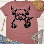 Women's funny woodworking graphic tee shirt for female woodworkers, makers, and DIY builders — Sawdust & Ponytails. Dusty rose t-shirt with a black graphic of a Highland cow holding a power drill.