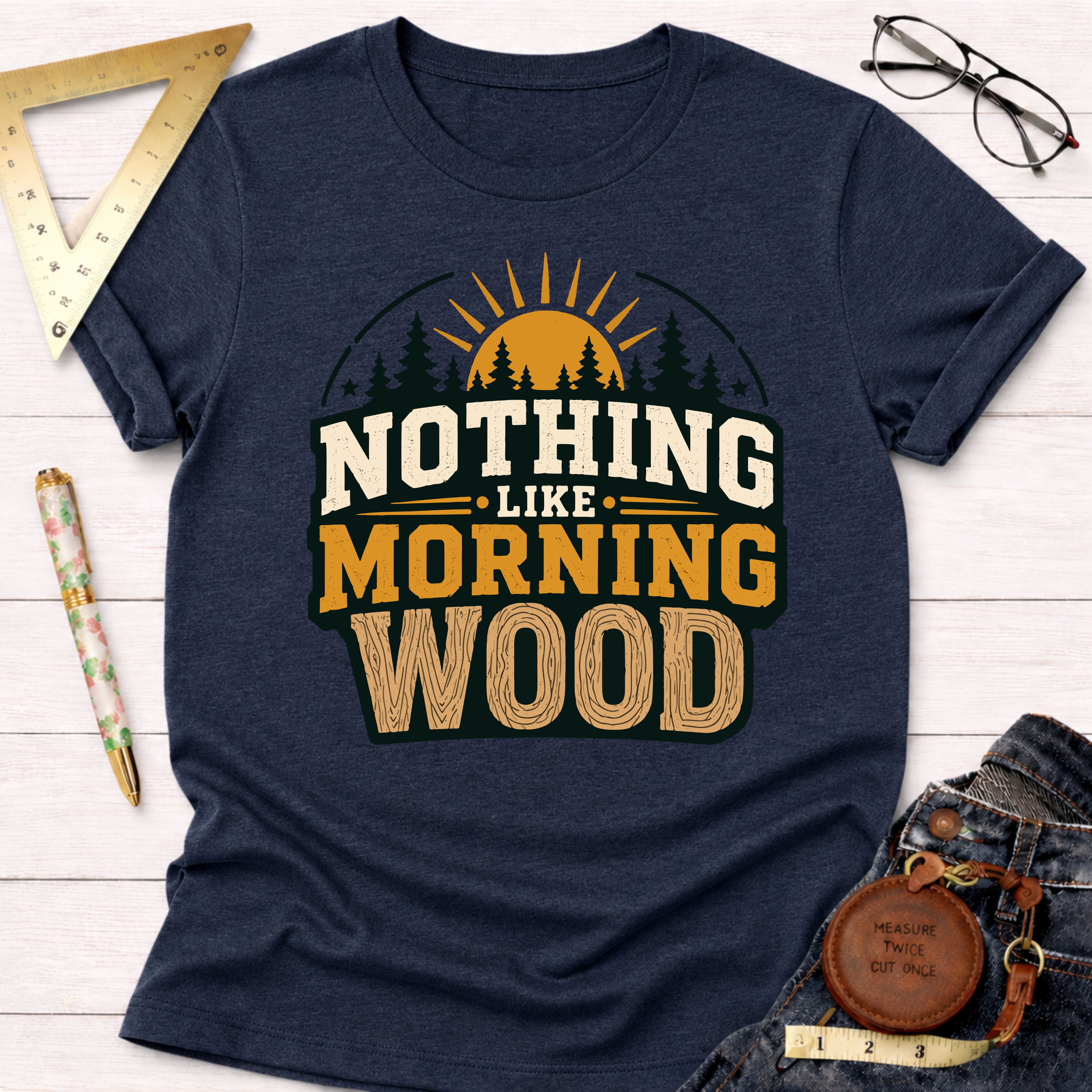 Navy blue heather t-shirt with "NOTHING LIKE MORNING WOOD" text, sun, and trees graphic.