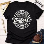 Black cotton t-shirt with "Morning Wood Timber Co. We Work Hard" logo featuring a tree ring graphic.