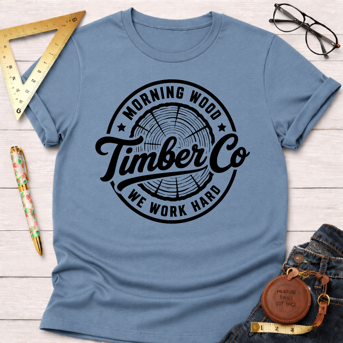 Morning Wood Timber Co. blue cotton t-shirt with black circular logo featuring tree rings.