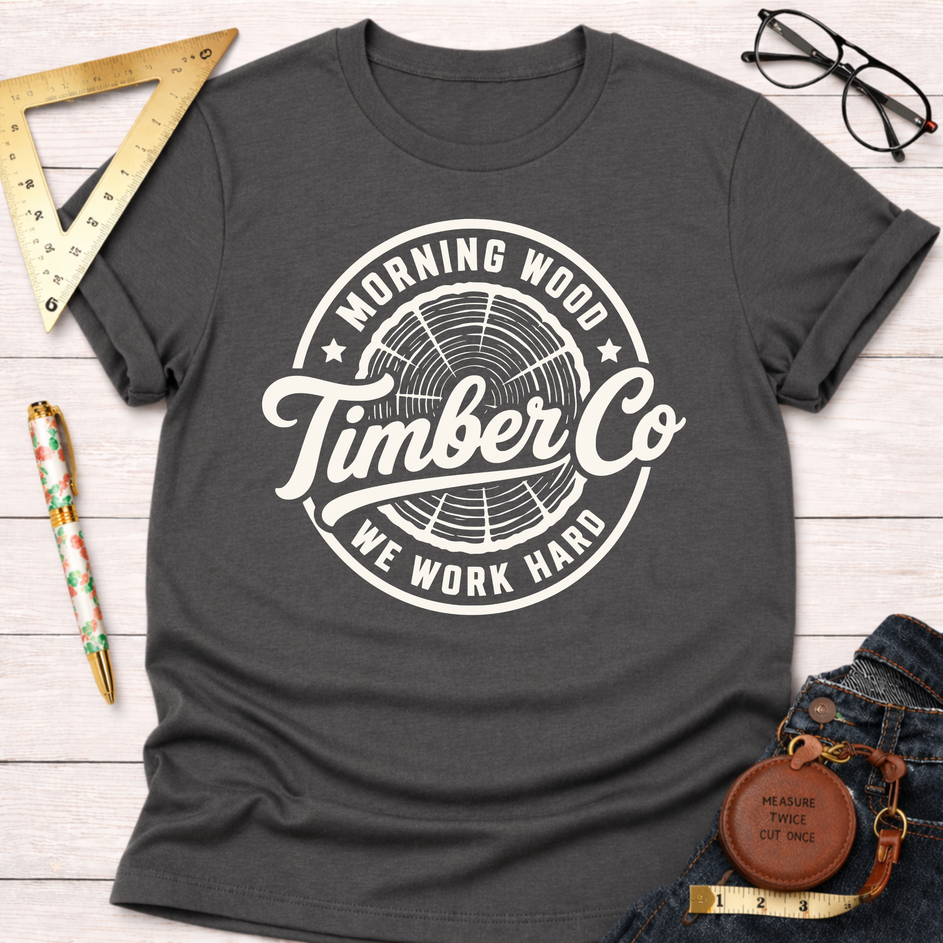 Charcoal gray "Morning Wood Timber Co." t-shirt with white logo, featuring a tree ring graphic.