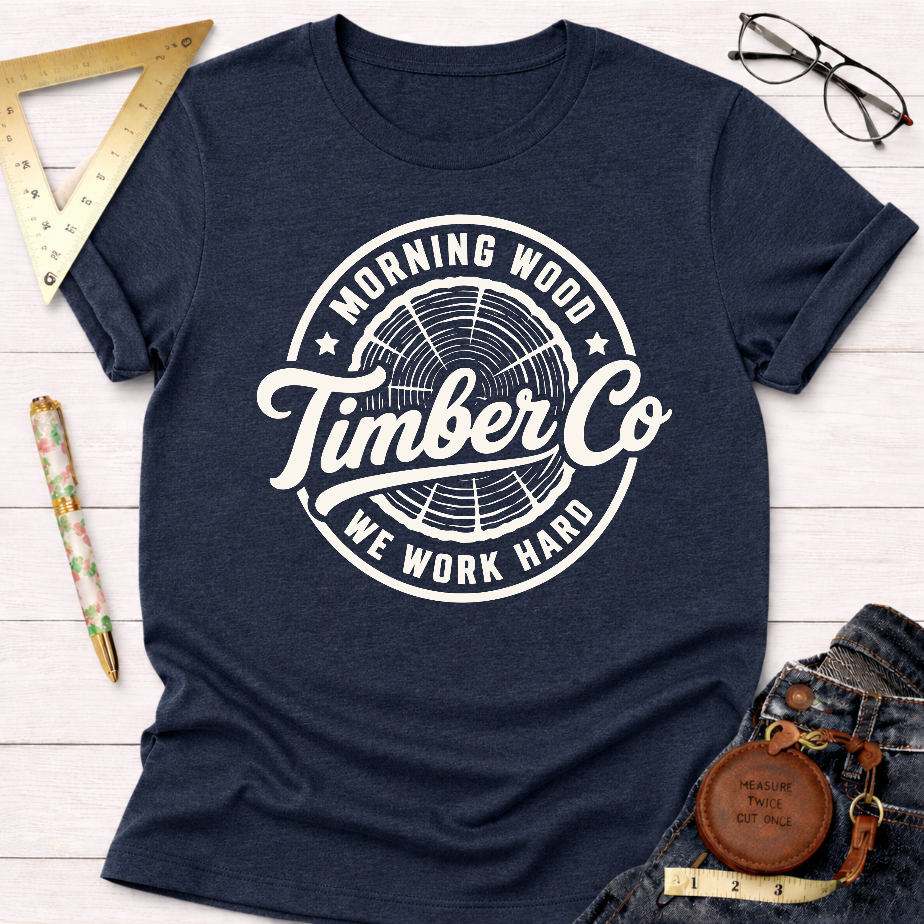 Navy blue "Morning Wood Timber Co." graphic tee with white tree ring logo.