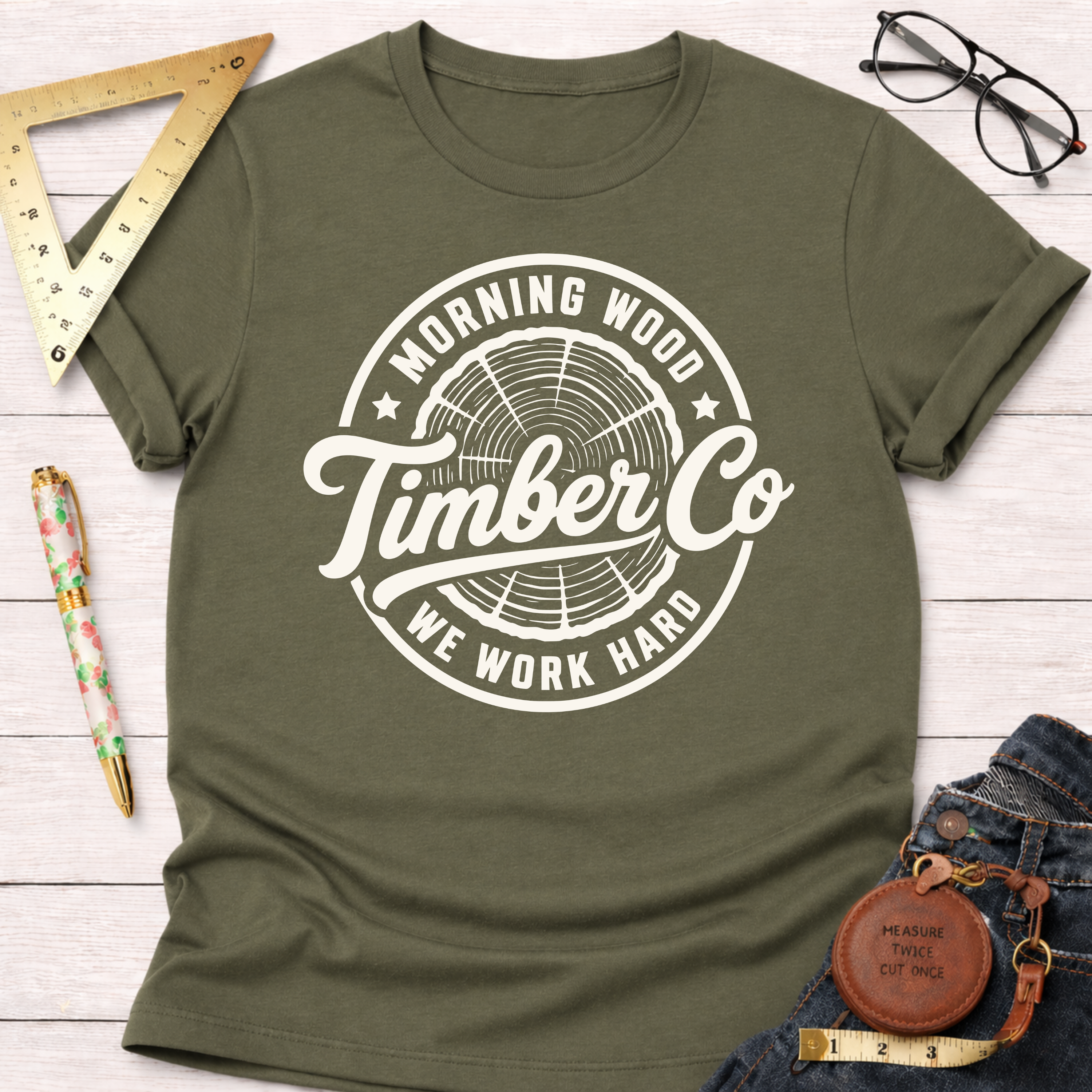 Morning Wood Timber Co. cream t-shirt with a dark blue tree ring logo.