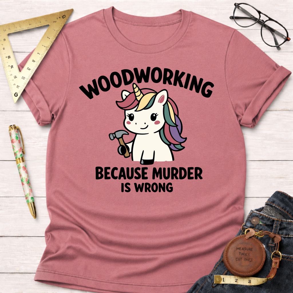 Pink heather t-shirt with a cute unicorn holding a hammer and "Woodworking Because Murder Is Wrong" text.