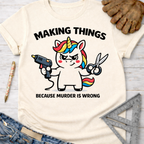 Women's funny woodworking graphic tee shirt for female woodworkers, makers, and DIY builders — Sawdust & Ponytails. Cream t-shirt with a unicorn holding a glue gun and scissors, text "MAKING THINGS BECAUSE MURDER IS WRONG".