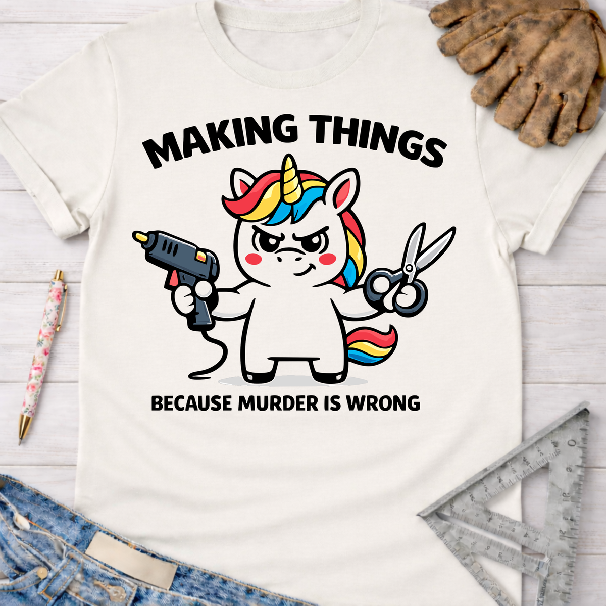 Women's funny woodworking graphic tee shirt for female woodworkers, makers, and DIY builders — Sawdust & Ponytails. White cotton tee with a unicorn holding a glue gun and scissors, text "MAKING THINGS BECAUSE MURDER IS WRONG".