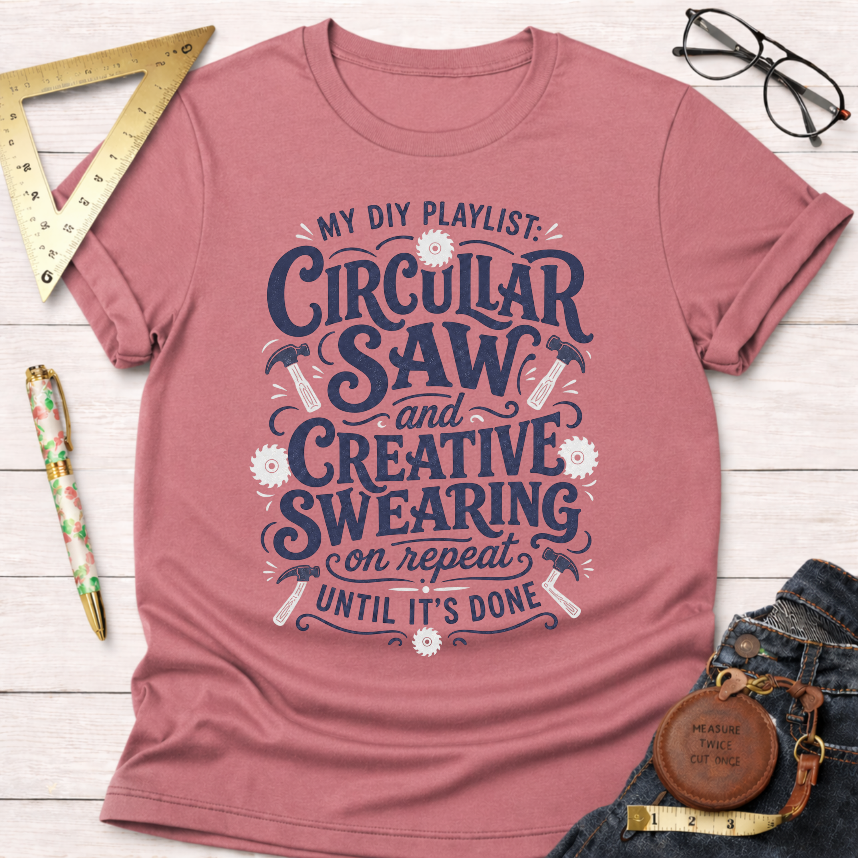 Women's funny woodworking graphic tee shirt for female woodworkers, makers, and DIY builders — Sawdust & Ponytails. Heather mauve t-shirt with "My DIY Playlist: Circular Saw and Creative Swearing on repeat until it's done" graphic.