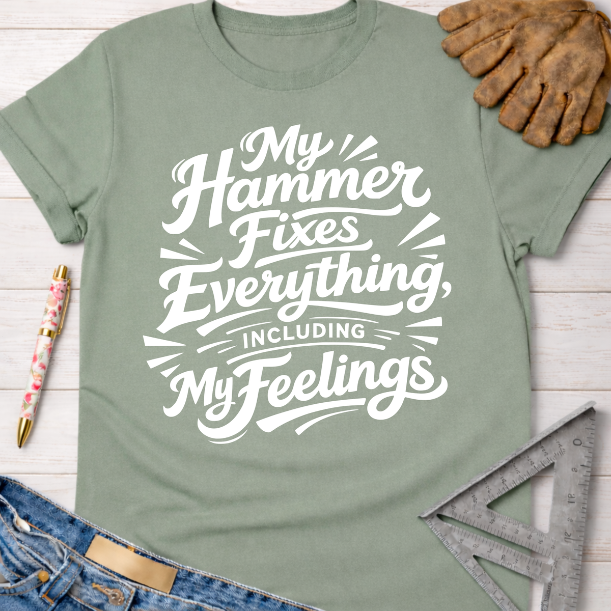 Women's funny woodworking graphic tee shirt for female woodworkers, makers, and DIY builders — Sawdust & Ponytails. Sage green cotton t-shirt with "My Hammer Fixes Everything, Including My Feelings" in white script.