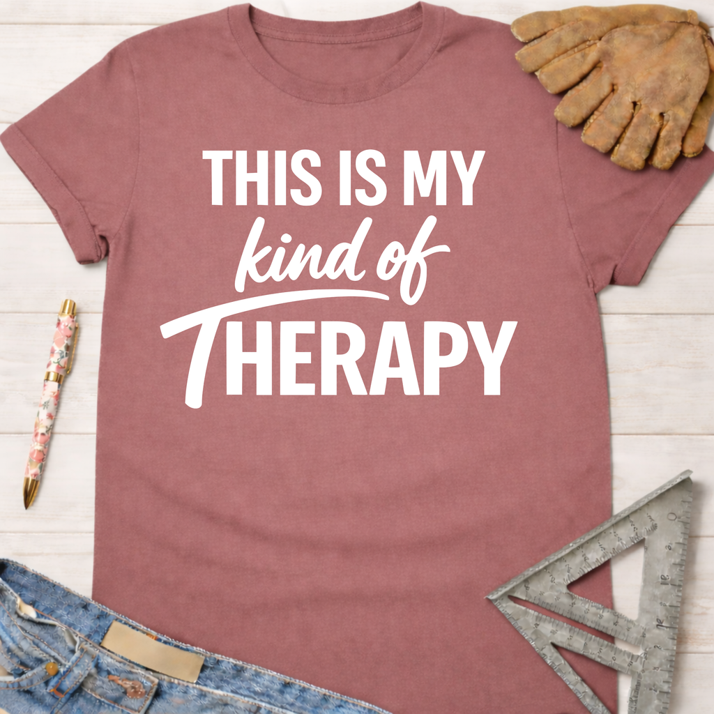 Women's funny woodworking graphic tee shirt for female woodworkers, makers, and DIY builders — Sawdust & Ponytails. Mauve cotton tee with "THIS IS MY kind of THERAPY" in white text.