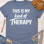 Women's funny woodworking graphic tee shirt for female woodworkers, makers, and DIY builders — Sawdust & Ponytails. Blue cotton tee with "THIS IS MY kind of THERAPY" in white text.