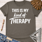 Women's funny woodworking graphic tee shirt for female woodworkers, makers, and DIY builders — Sawdust & Ponytails. Dark gray cotton tee with "THIS IS MY kind of THERAPY" in white text.