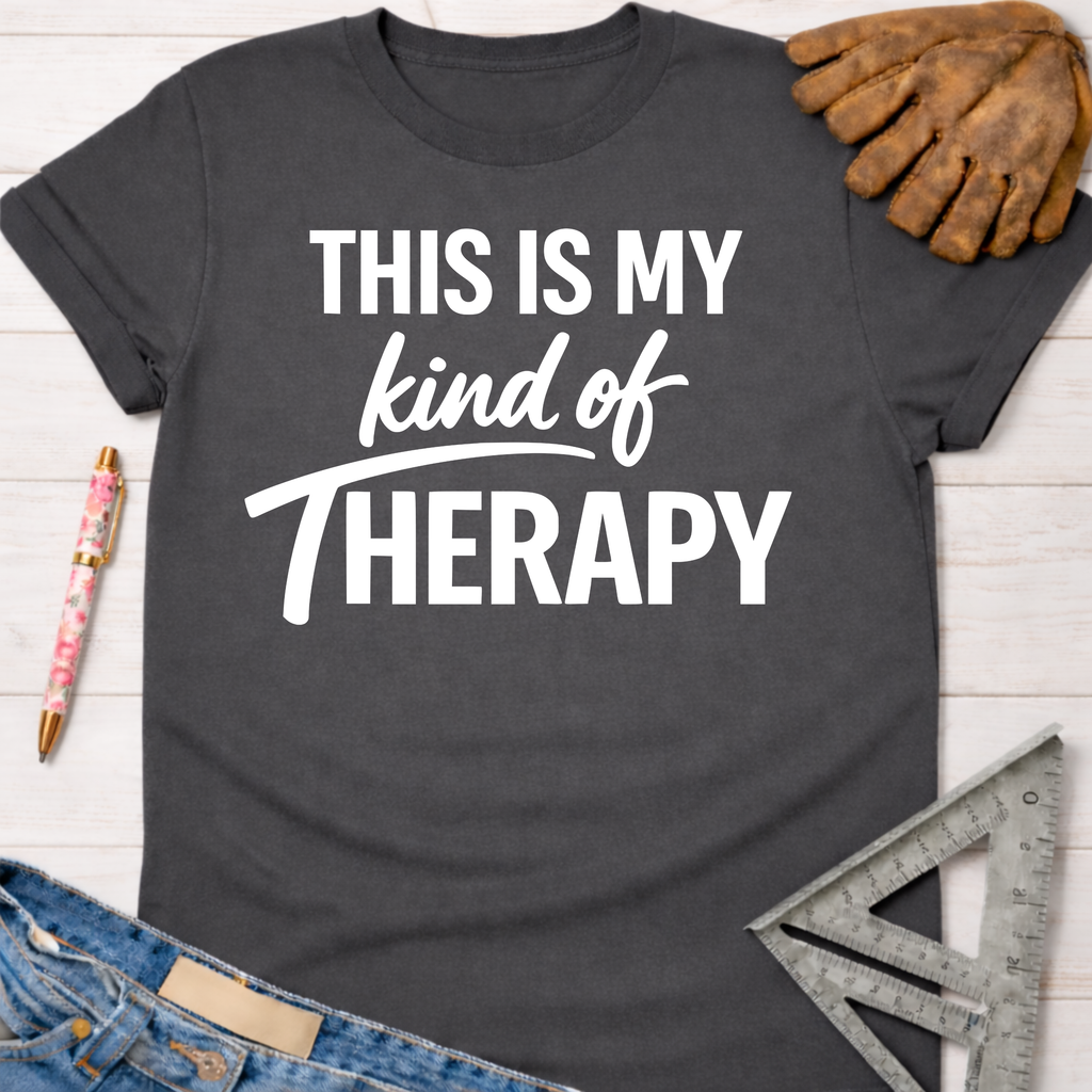 Women's funny woodworking graphic tee shirt for female woodworkers, makers, and DIY builders — Sawdust & Ponytails. Dark gray cotton tee with "THIS IS MY kind of THERAPY" in white text.