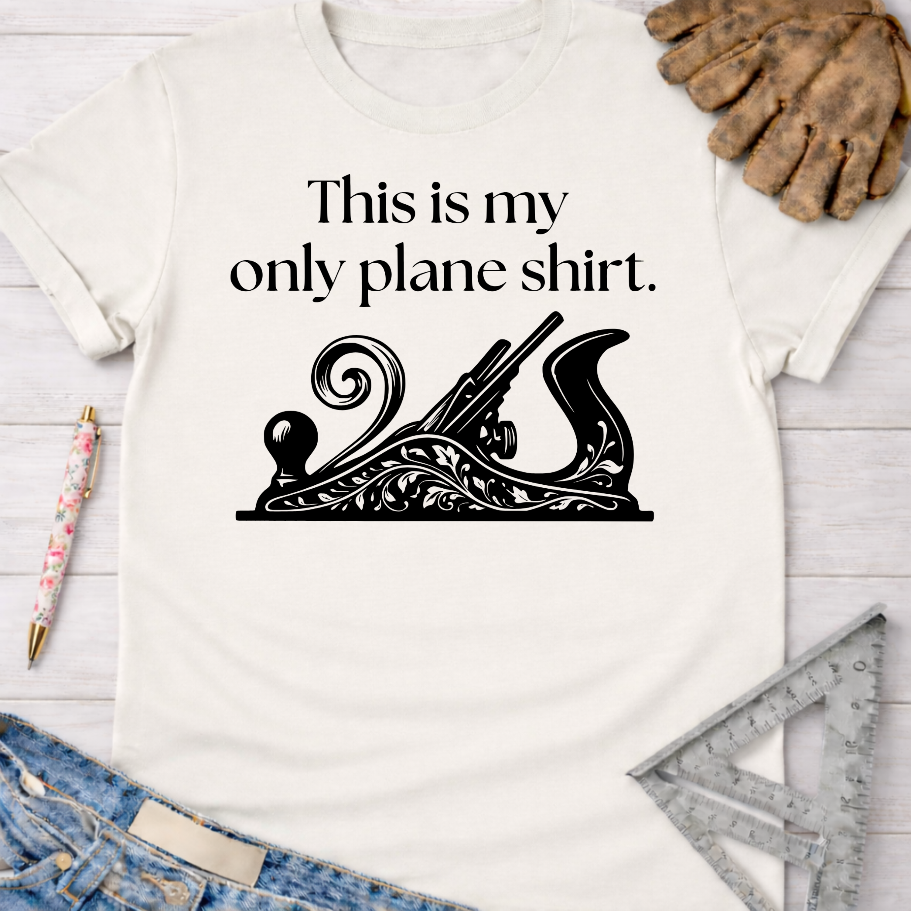 Women's funny woodworking graphic tee shirt for female woodworkers, makers, and DIY builders — Sawdust & Ponytails. White cotton tee with "This is my only plane shirt" text and ornate hand plane graphic.