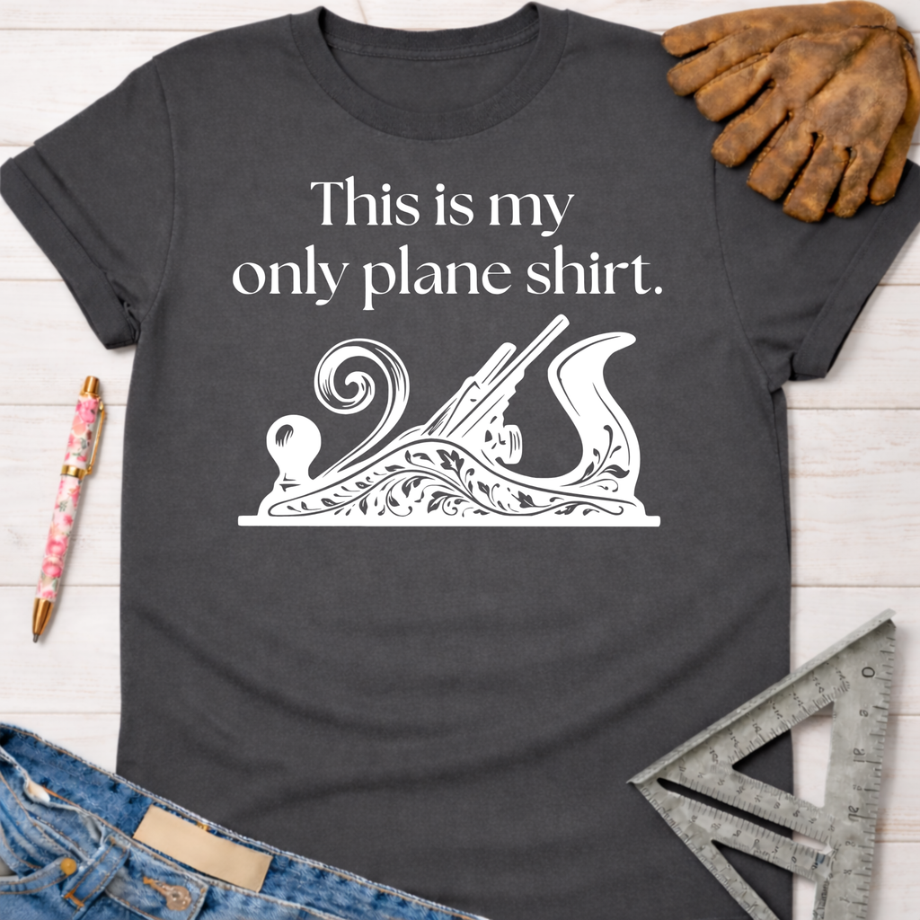 Women's funny woodworking graphic tee shirt for female woodworkers, makers, and DIY builders — Sawdust & Ponytails. Dark gray cotton t-shirt with "This is my only plane shirt" text and a decorative hand plane graphic.