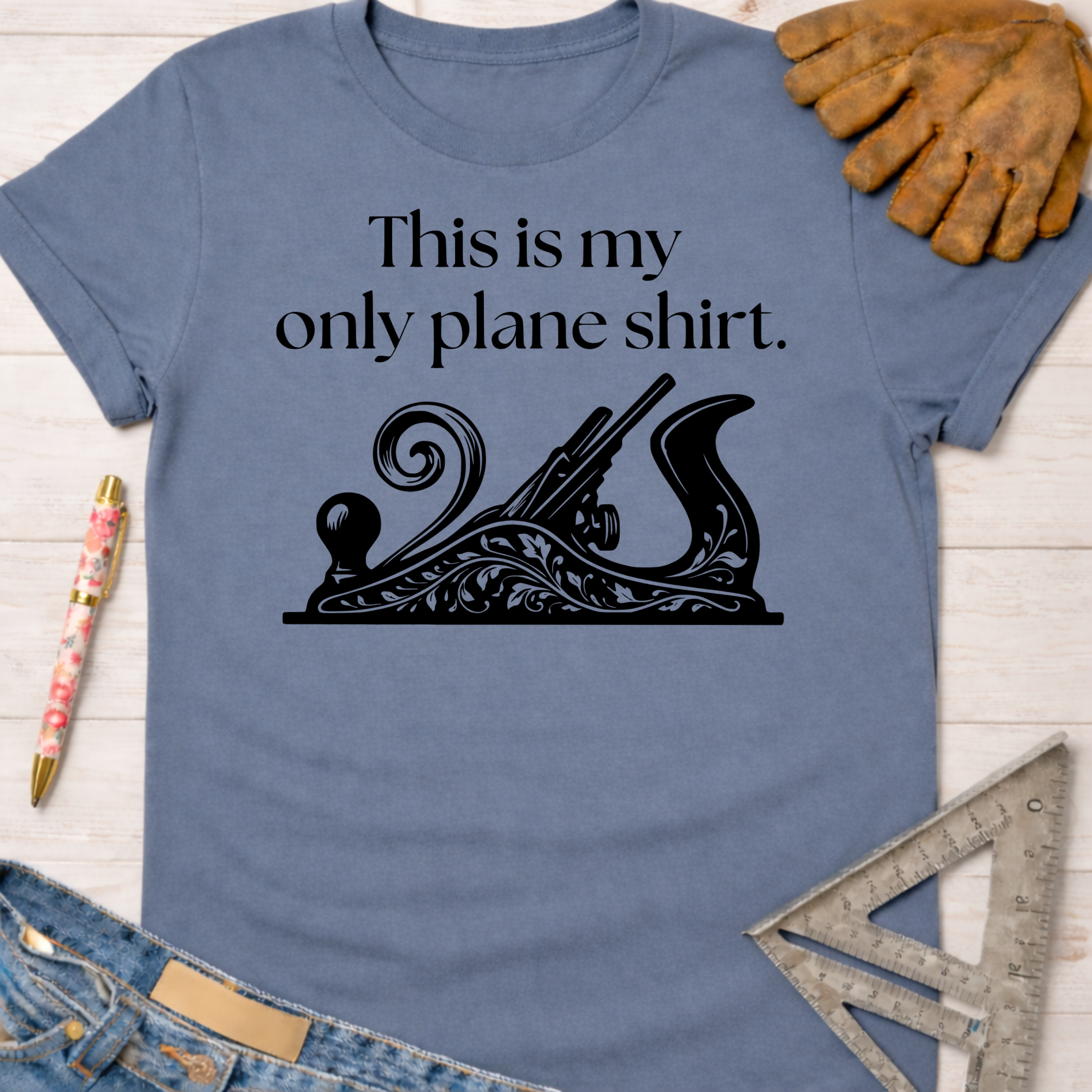 Women's funny woodworking graphic tee shirt for female woodworkers, makers, and DIY builders — Sawdust & Ponytails. Blue cotton tee with "This is my only plane shirt" text and a black hand plane graphic.
