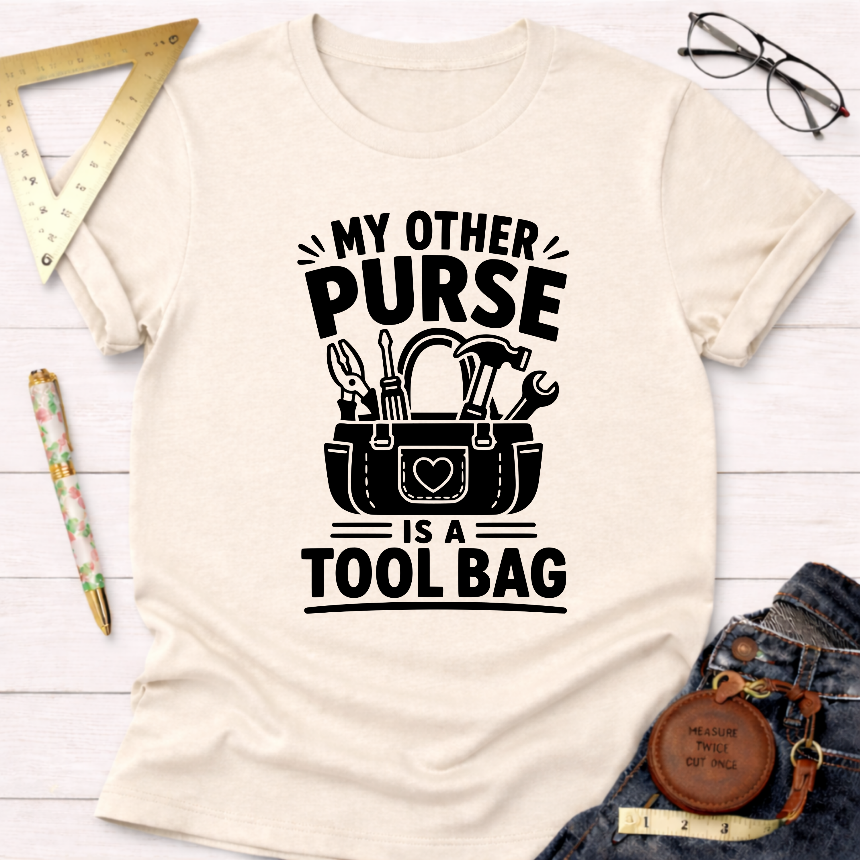 Cream t-shirt with "My Other Purse Is a Tool Bag" in black text and a tool bag graphic.