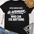 Black cotton "Never Underestimate A Woman Who Can Fix Anything" graphic tee with work gloves and tools. Women's funny woodworking graphic tee shirt for female woodworkers, makers, and DIY builders — Sawdust & Ponytails