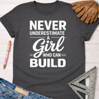 Women's funny woodworking graphic tee shirt for female woodworkers, makers, and DIY builders — Sawdust & Ponytails. Dark gray cotton t-shirt with "Never Underestimate A Girl Who Can Build" in white text.
