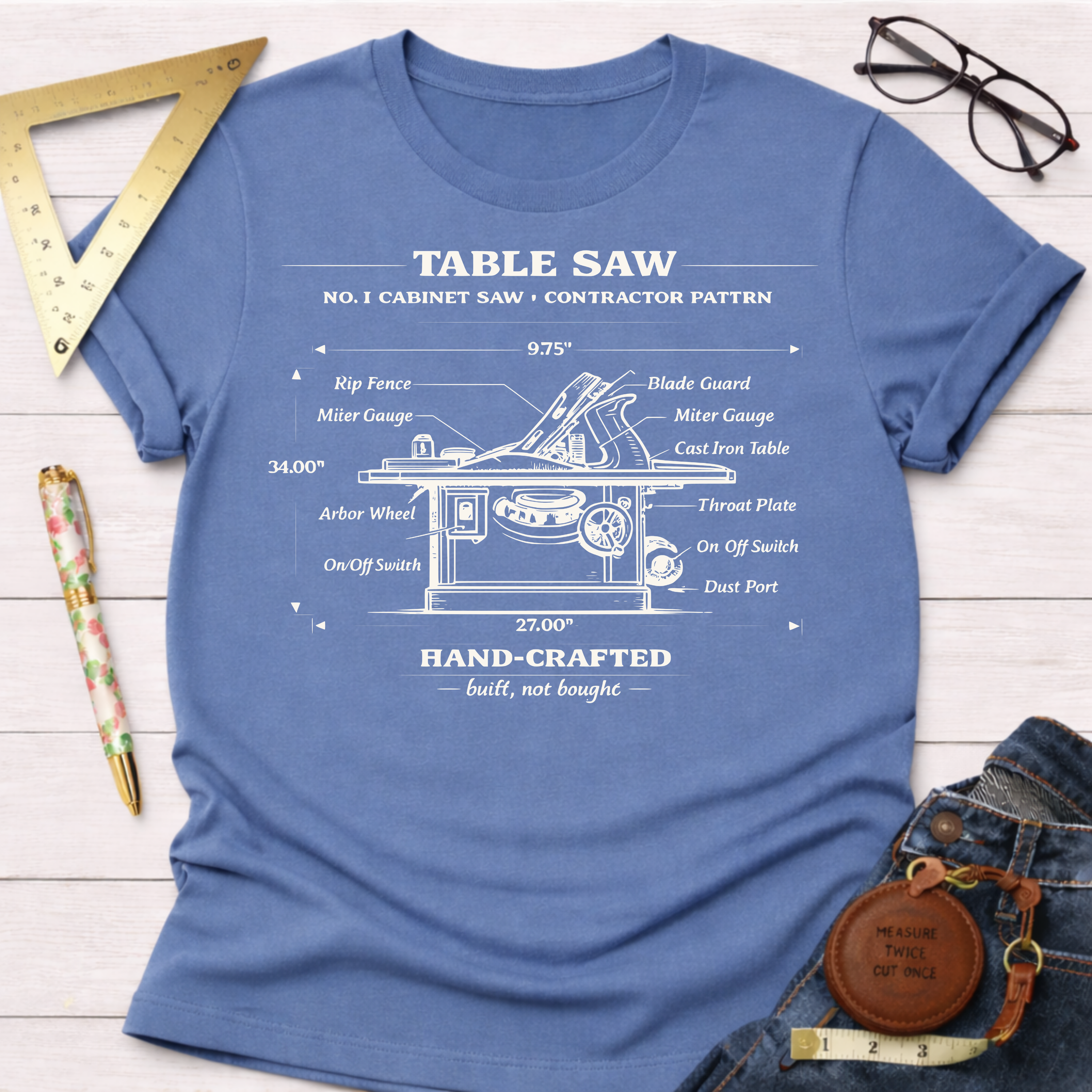 Women's funny woodworking graphic tee shirt for female woodworkers, makers, and DIY builders — Sawdust & Ponytails. Blue cotton tee with a white vintage table saw blueprint illustration.