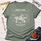 Olive green women's tee with white vintage table saw blueprint graphic. Women's funny woodworking graphic tee shirt for female woodworkers, makers, and DIY builders — Sawdust & Ponytails
