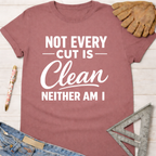 Women's funny woodworking graphic tee shirt for female woodworkers, makers, and DIY builders — Sawdust & Ponytails. Mauve t-shirt with "Not Every Cut Is Clean Neither Am I" in white text.