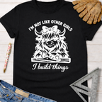 Black cotton tee with "I'm not like other girls, I build things" graphic featuring a Highland cow with a bow and woodworking tools. Women's funny woodworking graphic tee shirt for female woodworkers, makers, and DIY builders — Sawdust & Ponytails