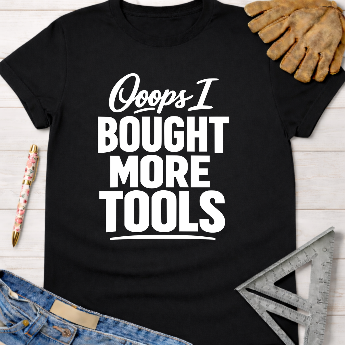 Women's funny woodworking graphic tee shirt for female woodworkers, makers, and DIY builders — Sawdust & Ponytails. Black cotton tee with "Ooops I BOUGHT MORE TOOLS" in white text.