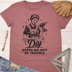 Women's funny woodworking graphic tee shirt for female woodworkers, makers, and DIY builders — Sawdust & Ponytails. Mauve cotton tee with "DIY Keeps Me Out Of Trouble" graphic.
