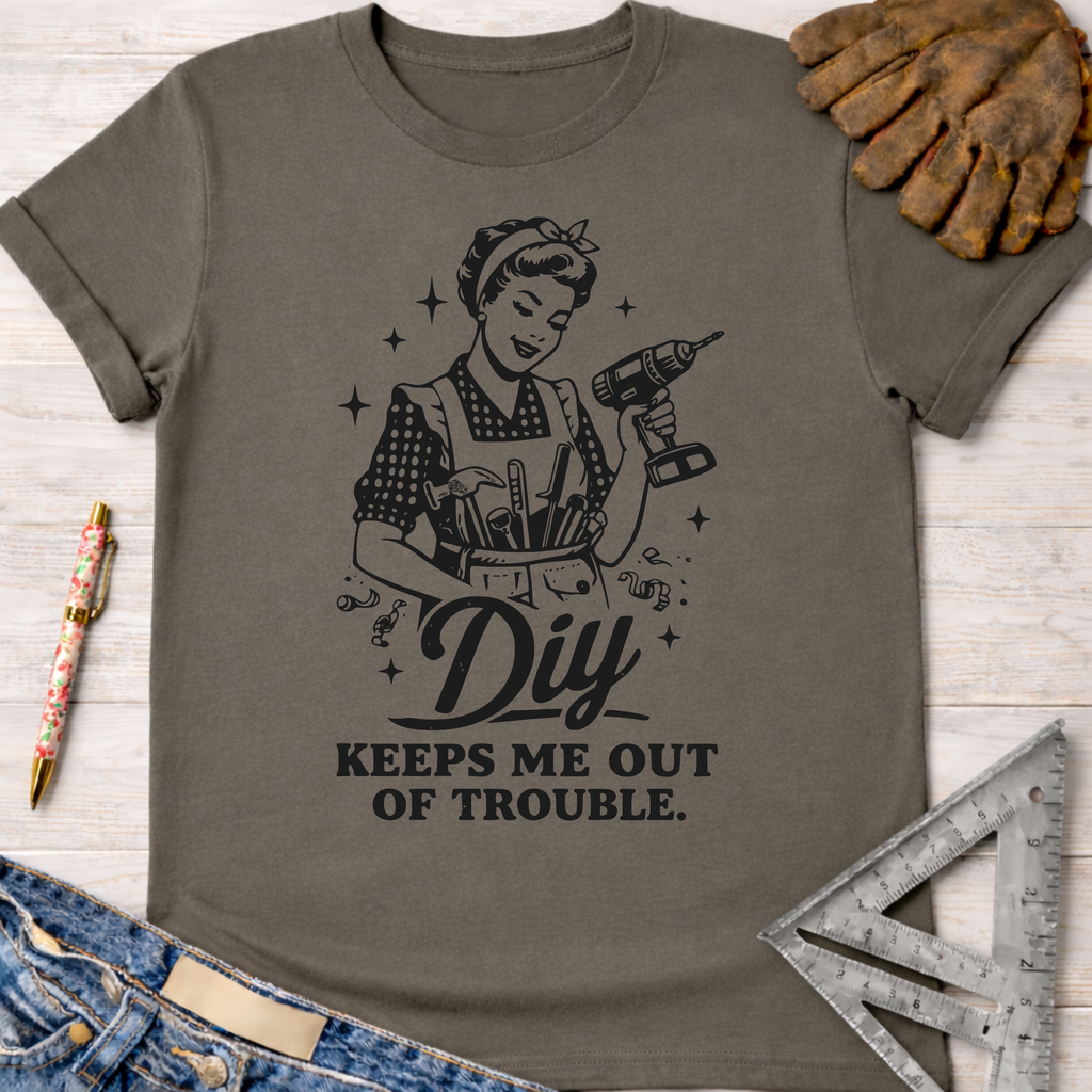 Charcoal grey cotton tee with "DIY Keeps Me Out Of Trouble" graphic, featuring a woman with a drill. Women's funny woodworking graphic tee shirt for female woodworkers, makers, and DIY builders — Sawdust & Ponytails.