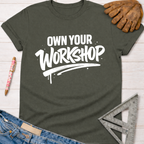 Women's funny woodworking graphic tee shirt for female woodworkers, makers, and DIY builders — Sawdust & Ponytails. Dark gray t-shirt with "Own Your Workshop" in white text.