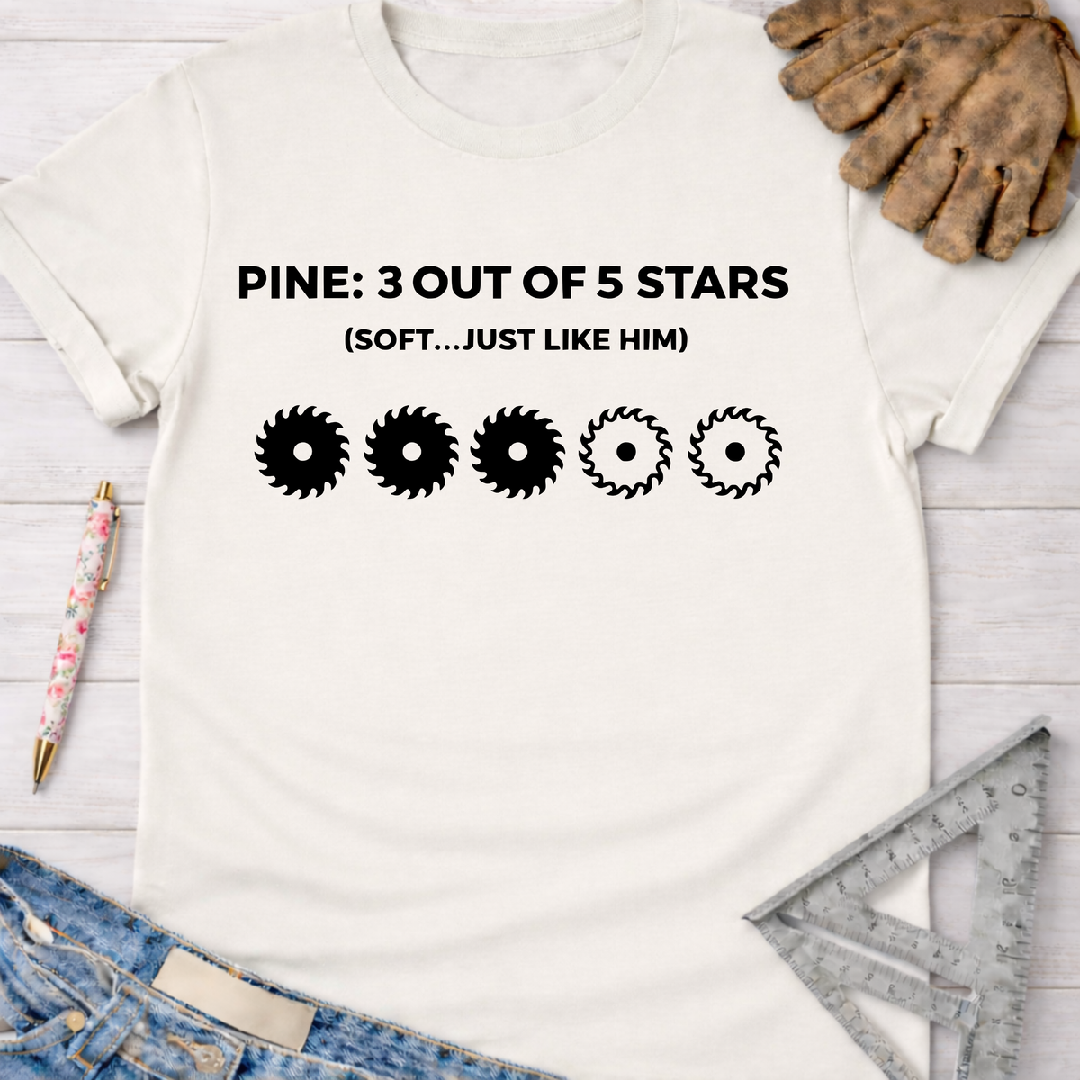 Women's funny woodworking graphic tee shirt for female woodworkers, makers, and DIY builders — Sawdust & Ponytails. White cotton tee with "PINE: 3 OUT OF 5 STARS (SOFT...JUST LIKE HIM)" and three full, two outline saw blade graphics.