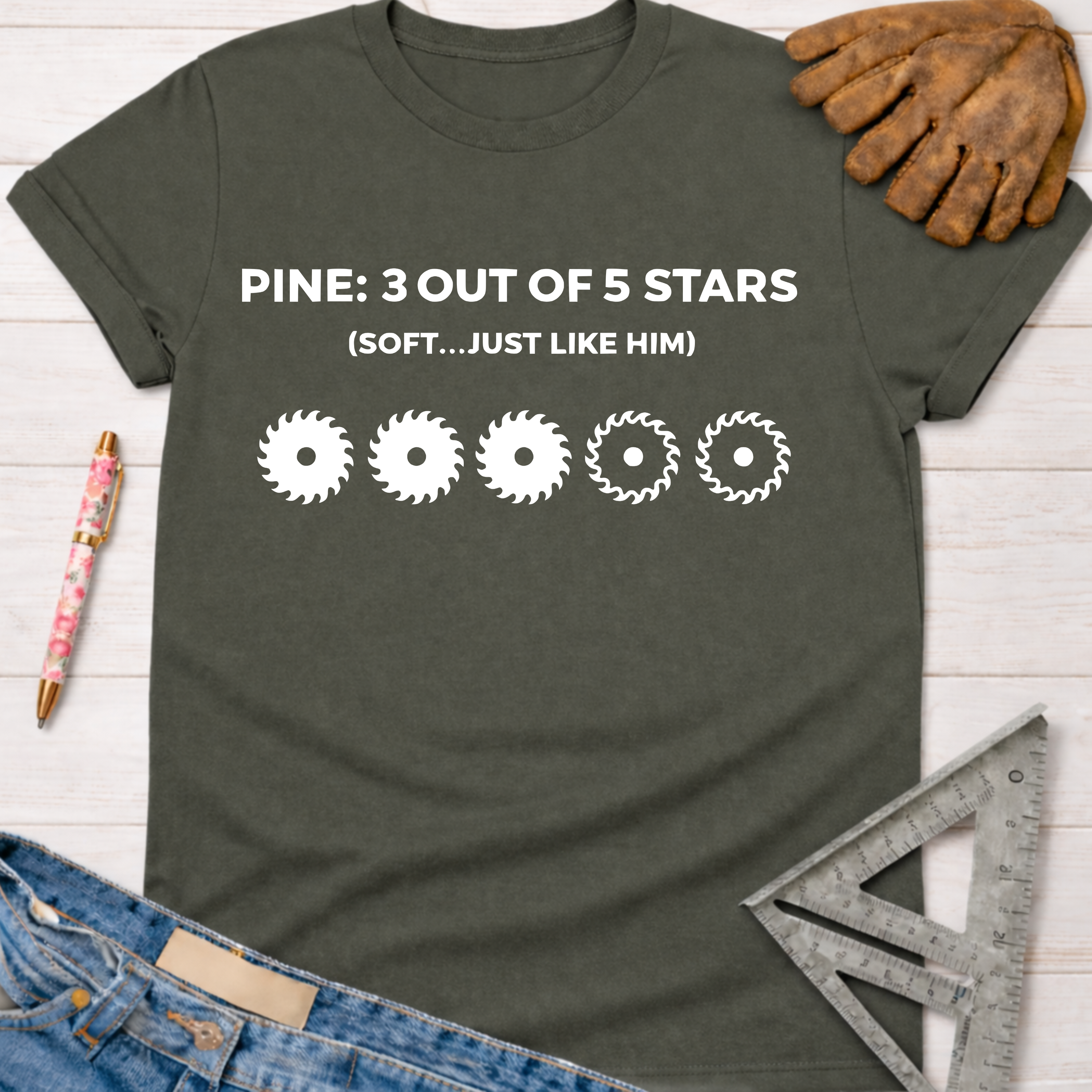 Women's funny woodworking graphic tee shirt for female woodworkers, makers, and DIY builders — Sawdust & Ponytails. Dark gray cotton tee with "PINE: 3 OUT OF 5 STARS (SOFT...JUST LIKE HIM)" and five saw blade graphics.