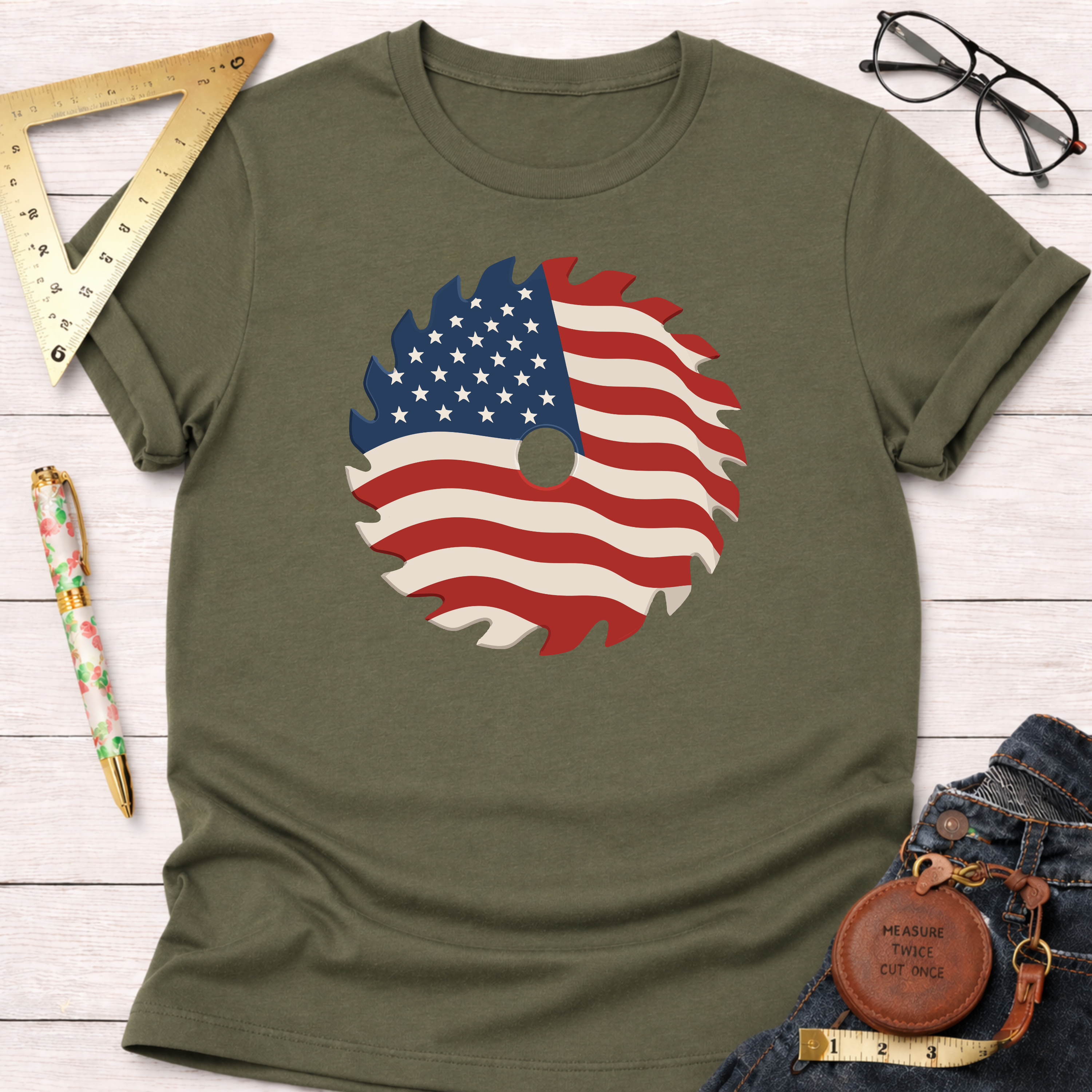 Olive green 100% cotton t-shirt with a patriotic American flag saw blade graphic.
