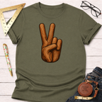 Olive green "Peace Love & Wood" t-shirt with a wood-textured peace sign graphic, laid flat with woodworking tools.