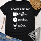 Women's funny woodworking graphic tee shirt for female woodworkers, makers, and DIY builders — Sawdust & Ponytails. Black cotton tee with "POWERED BY coffee, sawdust, wine" text.