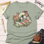 Green cotton t-shirt with a floral miter saw graphic, surrounded by pink peonies and white daisies.