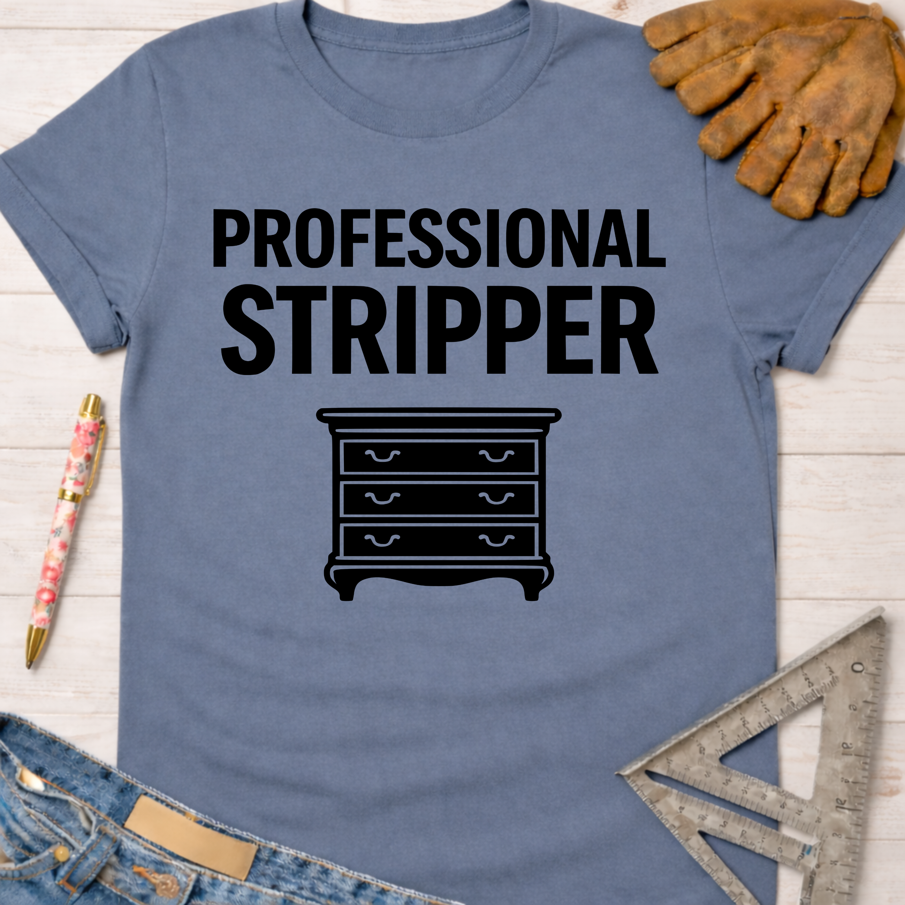 Women's funny woodworking graphic tee shirt for female woodworkers, makers, and DIY builders — Sawdust & Ponytails. Blue cotton tee with "Professional Stripper" text and a dresser graphic.