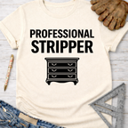 Women's funny woodworking graphic tee shirt for female woodworkers, makers, and DIY builders — Sawdust & Ponytails. Cream t-shirt with "PROFESSIONAL STRIPPER" and a dresser graphic.