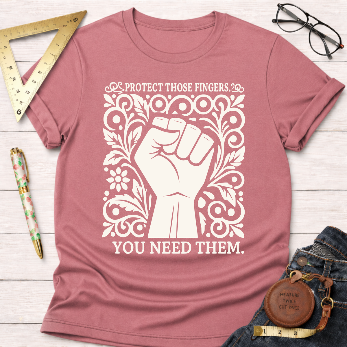 Heather dusty rose cotton t-shirt with "Protect Those Fingers. You Need Them." text and a white fist design.