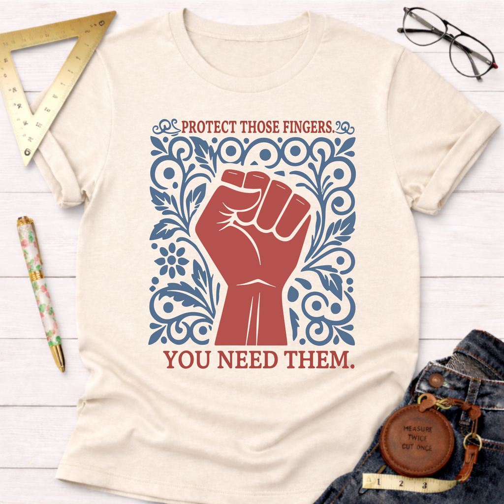 Cream t-shirt with a red fist and blue floral design, text reads "Protect Those Fingers. You Need Them.