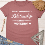 Women's funny woodworking graphic tee shirt for female woodworkers, makers, and DIY builders — Sawdust & Ponytails. Mauve cotton t-shirt with "In a Committed Relationship With My Workshop" text.
