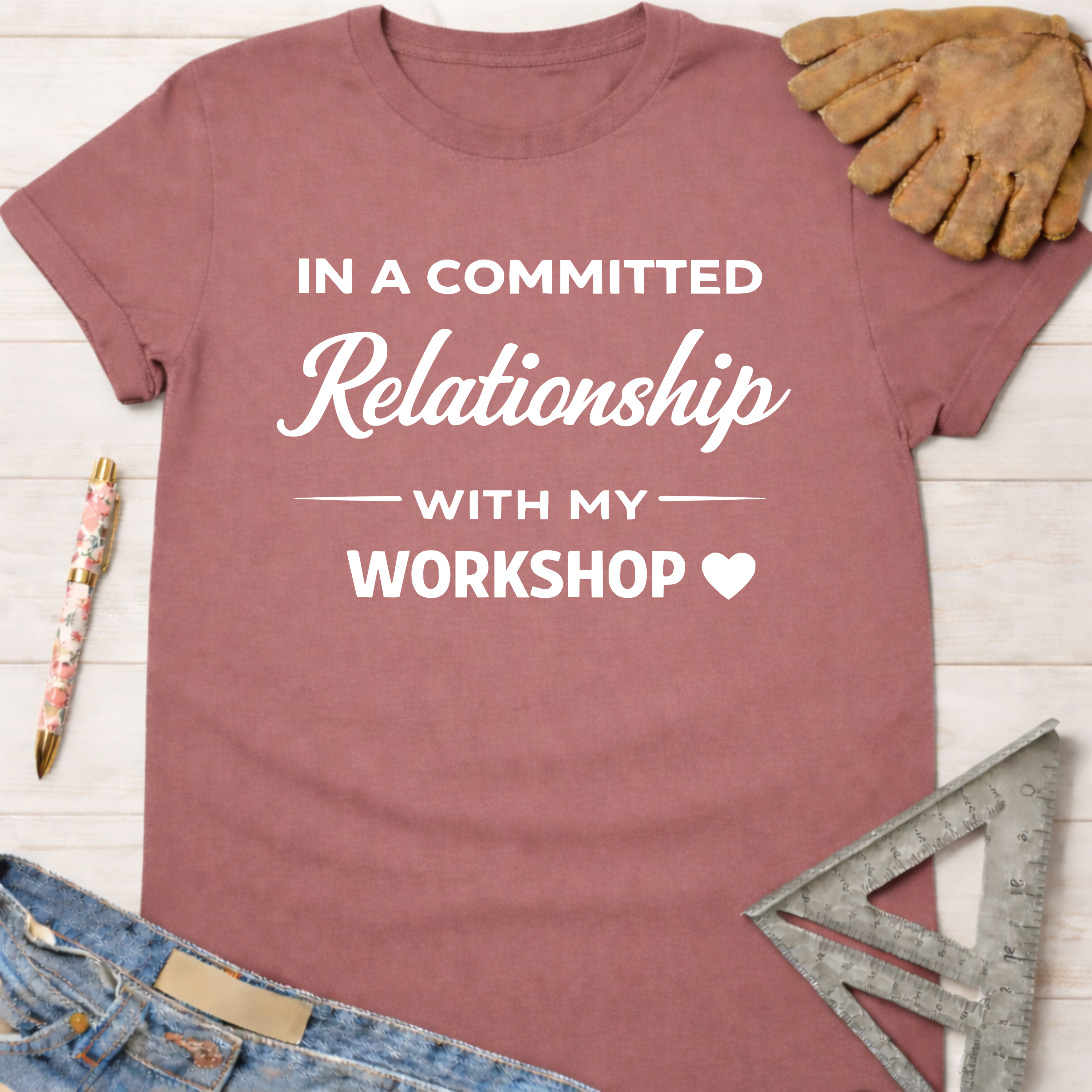 Women's funny woodworking graphic tee shirt for female woodworkers, makers, and DIY builders — Sawdust & Ponytails. Mauve cotton t-shirt with "In a Committed Relationship With My Workshop" text.