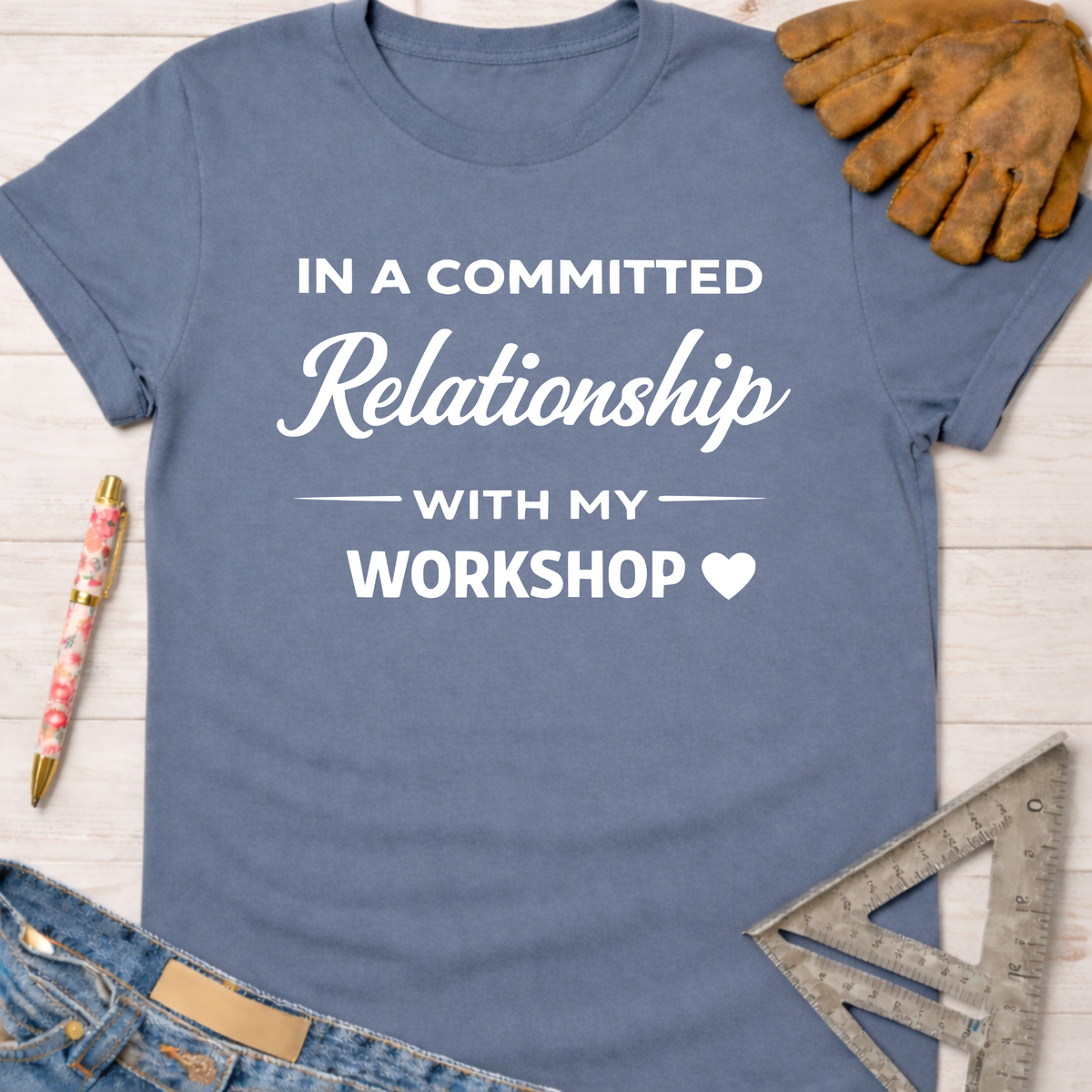 Women's funny woodworking graphic tee shirt for female woodworkers, makers, and DIY builders — Sawdust & Ponytails. Blue cotton tee with "In a Committed Relationship With My Workshop" text.