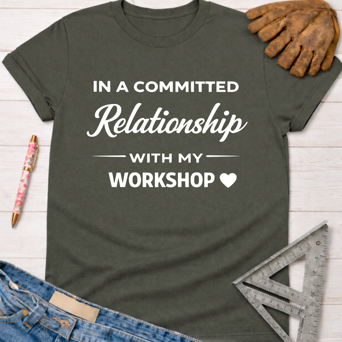 Women's funny woodworking graphic tee shirt for female woodworkers, makers, and DIY builders — Sawdust & Ponytails. Dark gray cotton tee with "In a Committed Relationship With My Workshop" in white text.