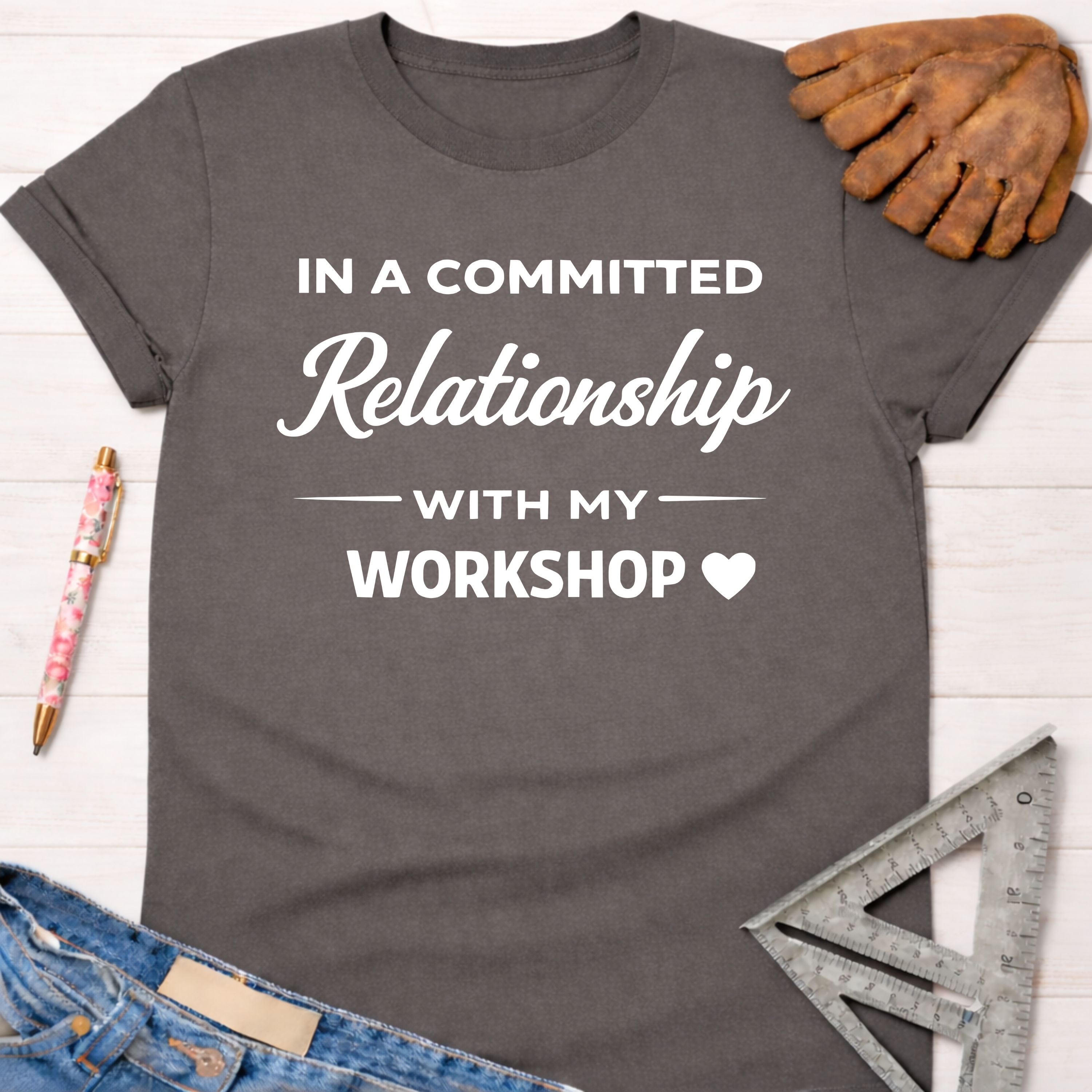 Women's funny woodworking graphic tee shirt for female woodworkers, makers, and DIY builders — Sawdust & Ponytails. Dark gray cotton tee with "In a Committed Relationship With My Workshop" text.