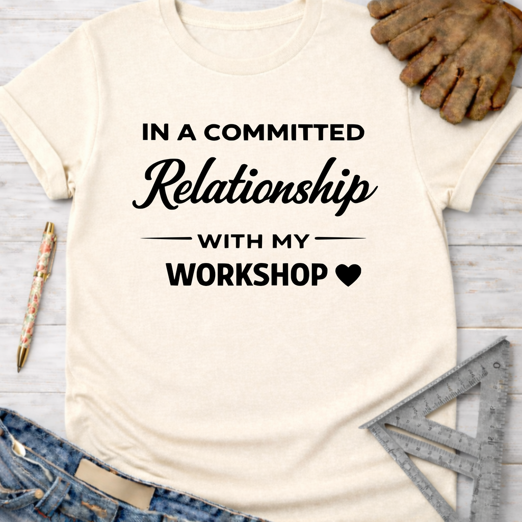Women's funny woodworking graphic tee shirt for female woodworkers, makers, and DIY builders — Sawdust & Ponytails. Cream t-shirt with "In a Committed Relationship with My Workshop" text.