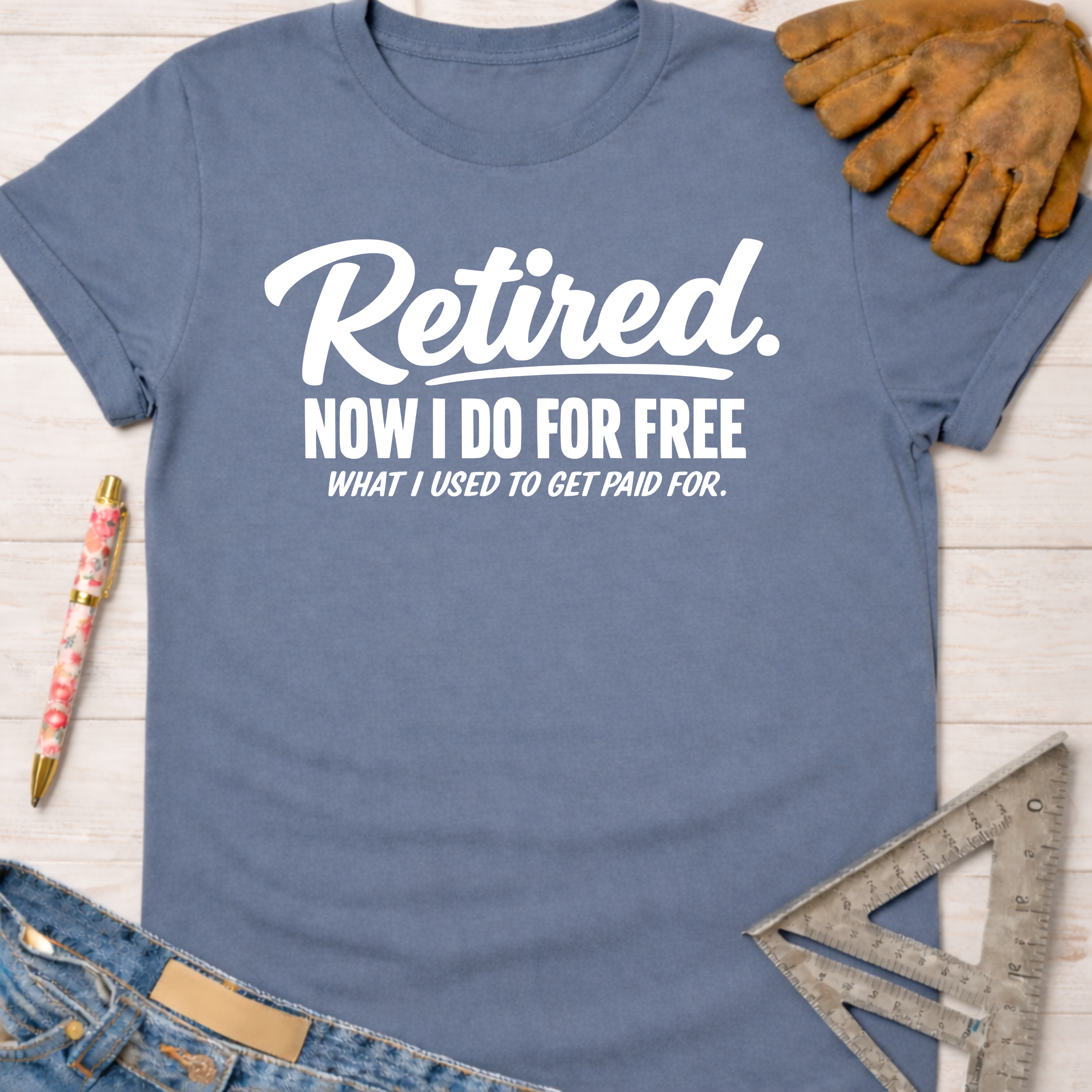 Women's funny woodworking graphic tee shirt for female woodworkers, makers, and DIY builders — Sawdust & Ponytails. Blue cotton tee with "Retired. Now I Do For Free What I Used To Get Paid For." in white text.