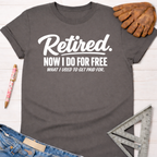 Women's funny woodworking graphic tee shirt for female woodworkers, makers, and DIY builders — Sawdust & Ponytails. Dark gray cotton tee with "Retired. Now I Do For Free What I Used To Get Paid For." in white text.