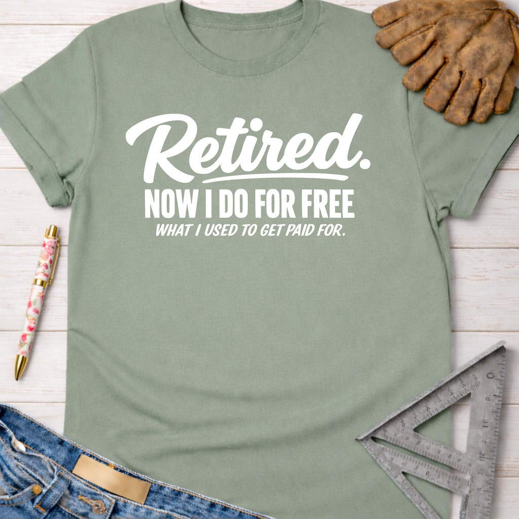 Women's funny woodworking graphic tee shirt for female woodworkers, makers, and DIY builders — Sawdust & Ponytails. Sage green cotton t-shirt with "Retired. Now I do for free what I used to get paid for." in white text.