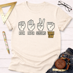 Cream short-sleeve t-shirt with "Rock Paper Scissors Table Saw" graphic featuring hand gestures.